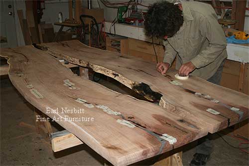 Earl taping cracks on mesquite slabs for custom made live edge dining table